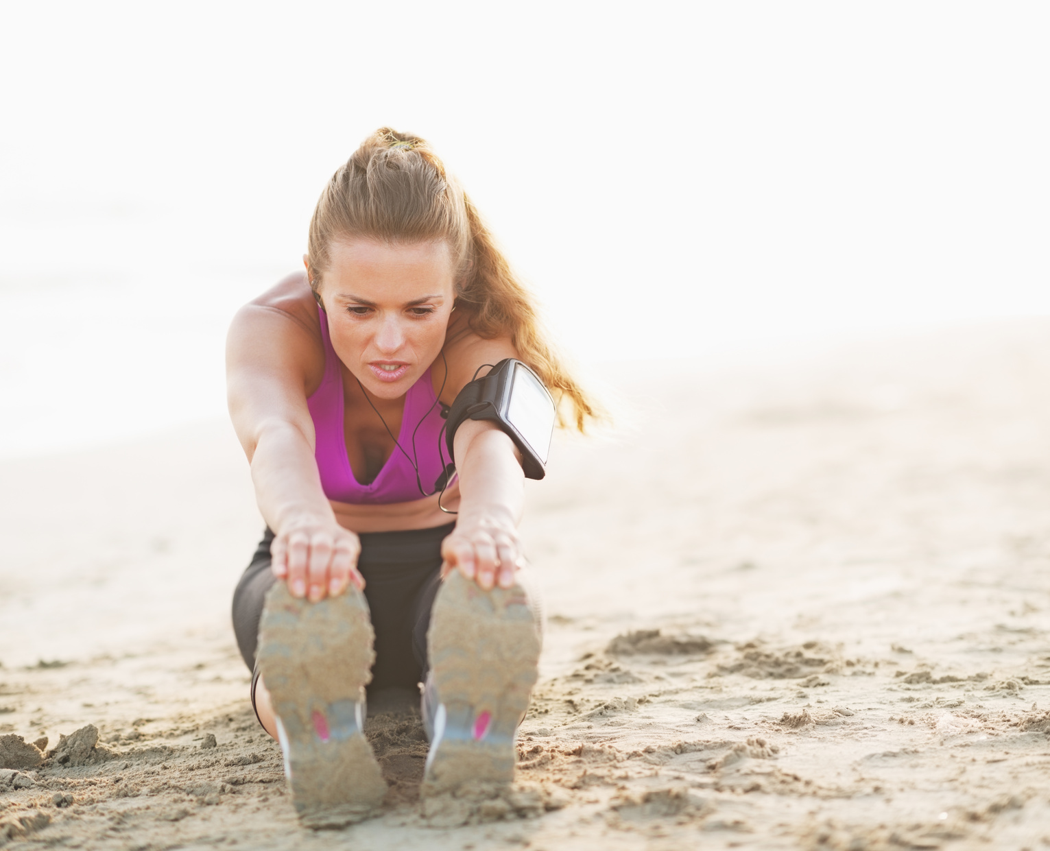 Fitness young woman making exercise on beach